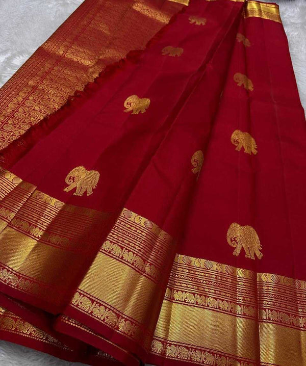 Red saree with gold elephant patterns on a white background