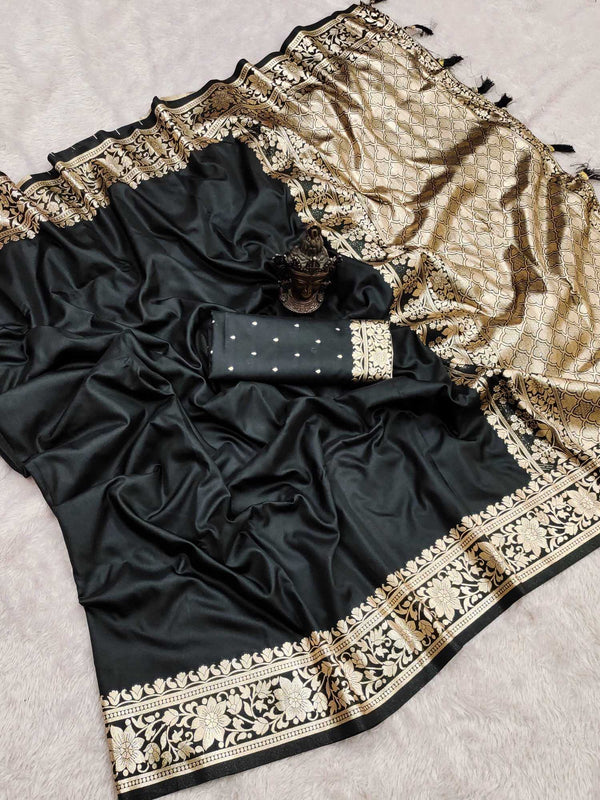 Black saree with gold embroidery on a light gray background