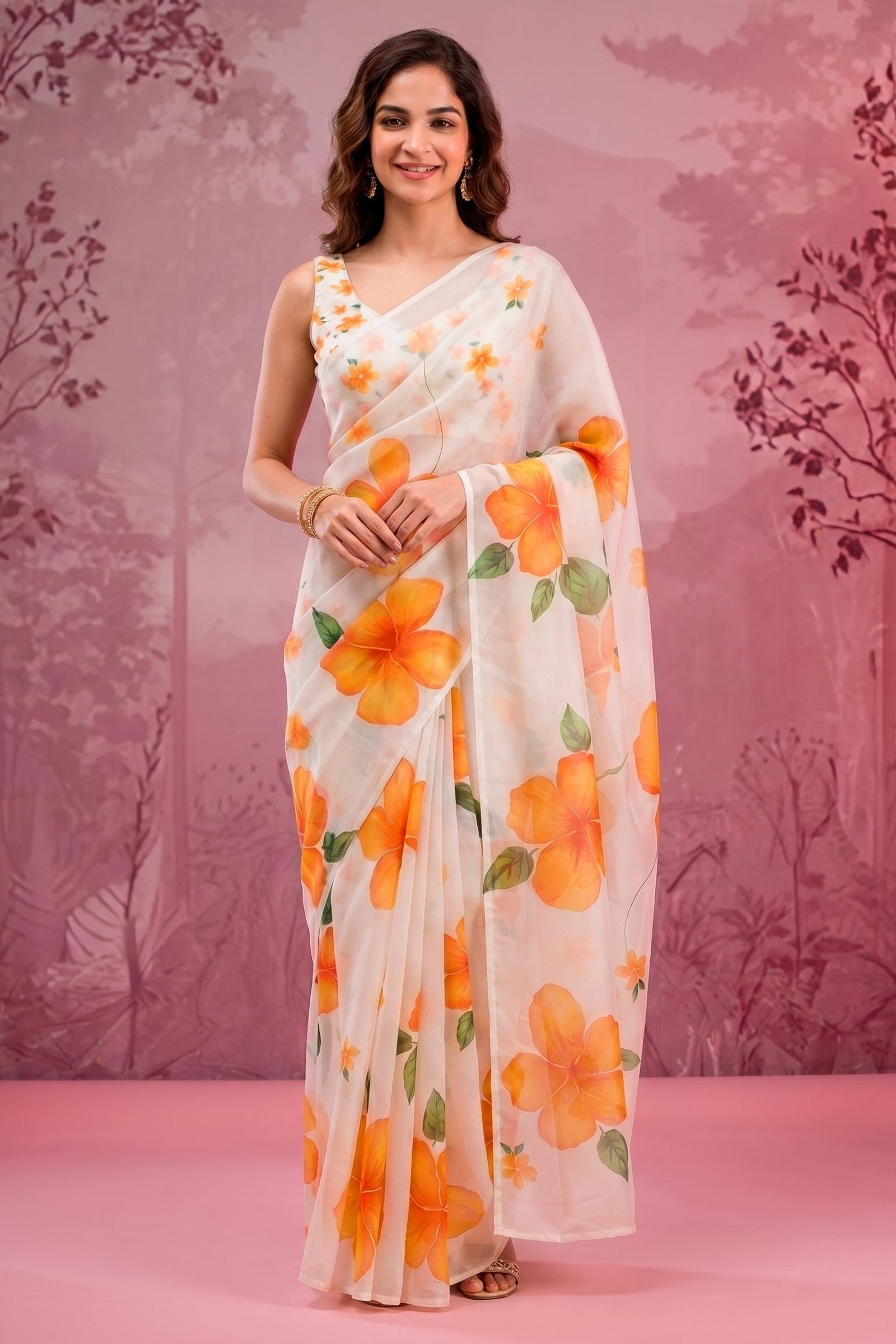 Woman wearing a floral saree with a pink background