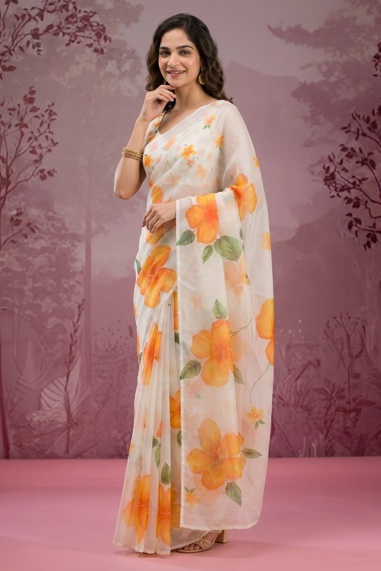 Woman wearing a floral saree with a pink background