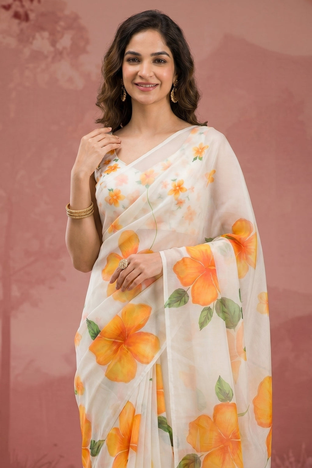 Woman wearing a white saree with orange floral patterns against a pinkish-brown background